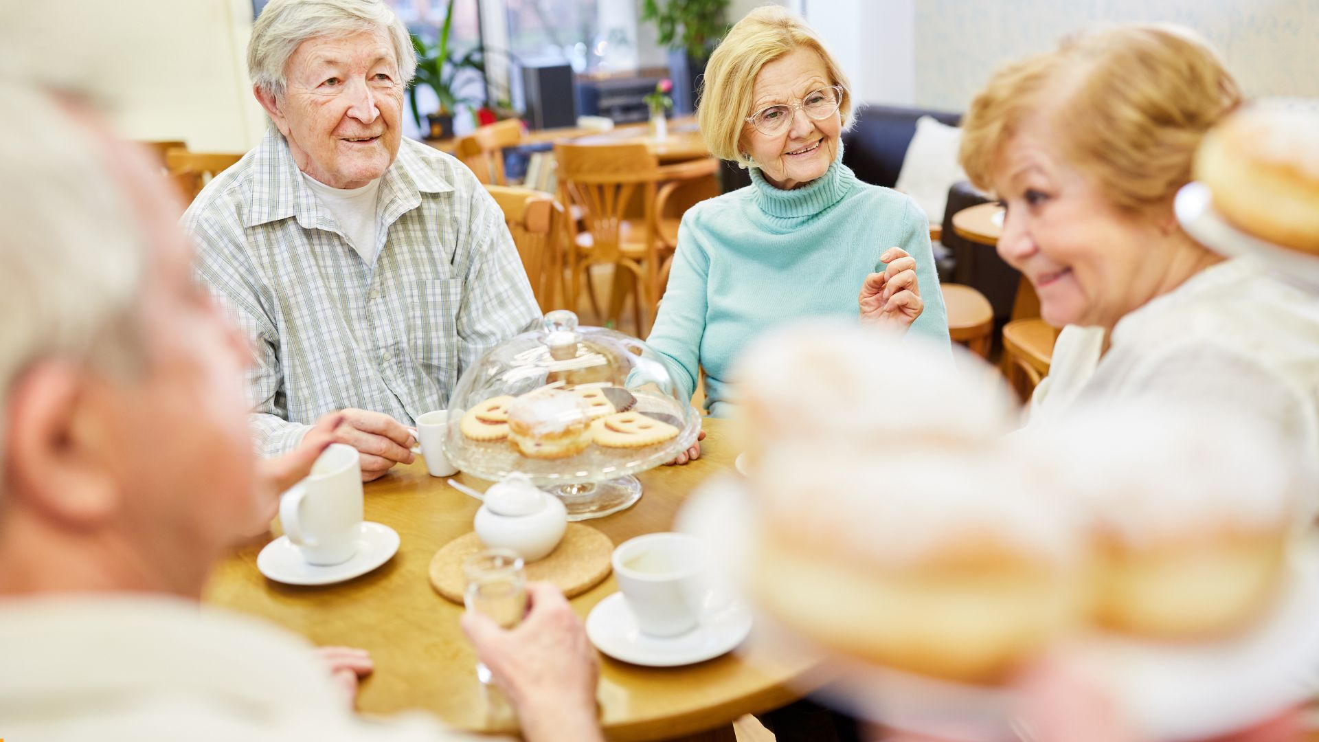 people sitting enjoying coffee and cake